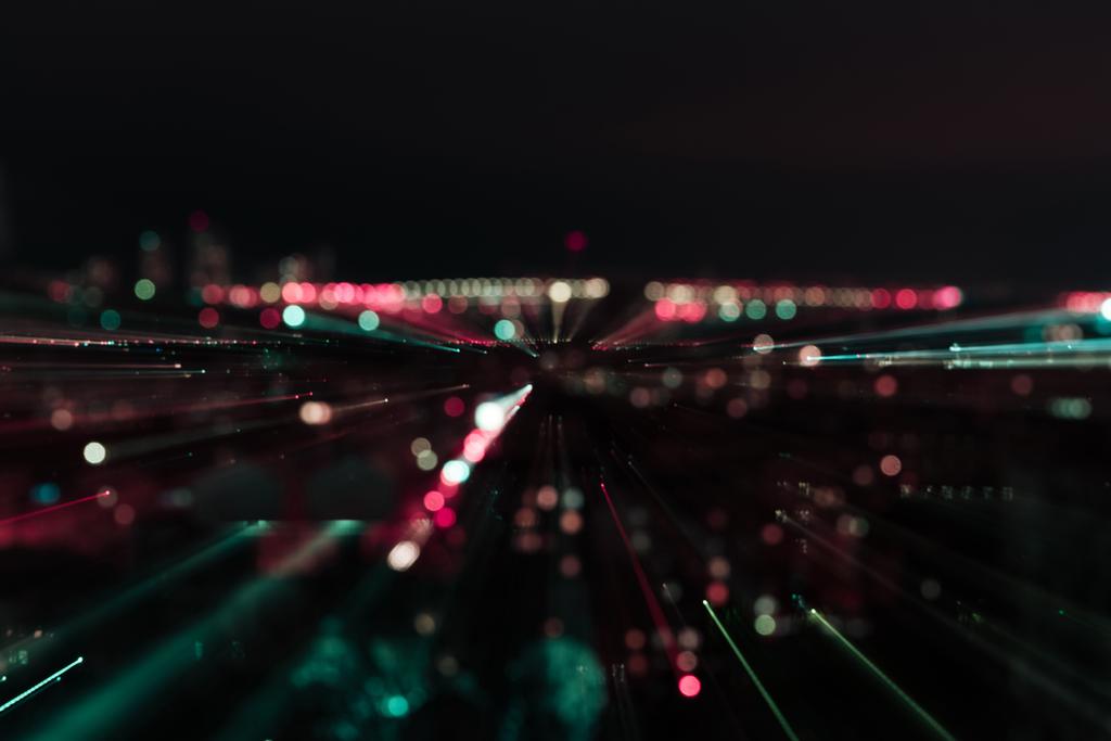 dark cityscape with blurred bright illumination at night - Photo, Image