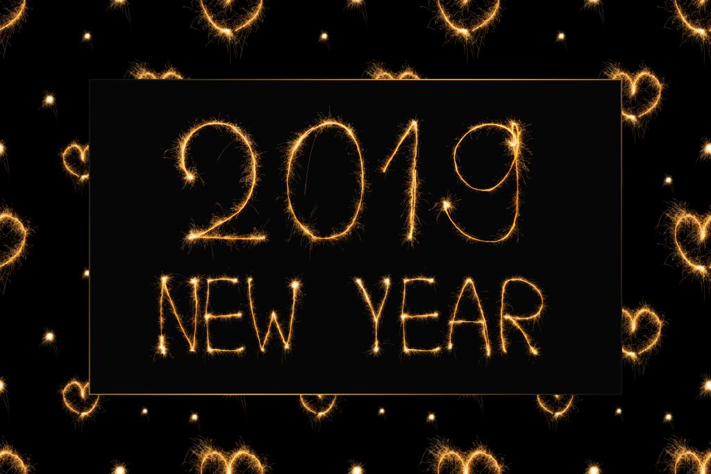 2019 new year light lettering and hearts light signs on black background - Photo, Image