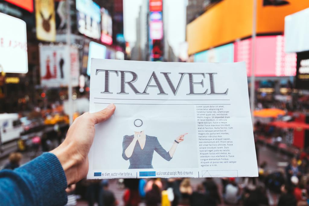 partial view of man holding business newspaper with blurry new york city street view on background - Photo, Image