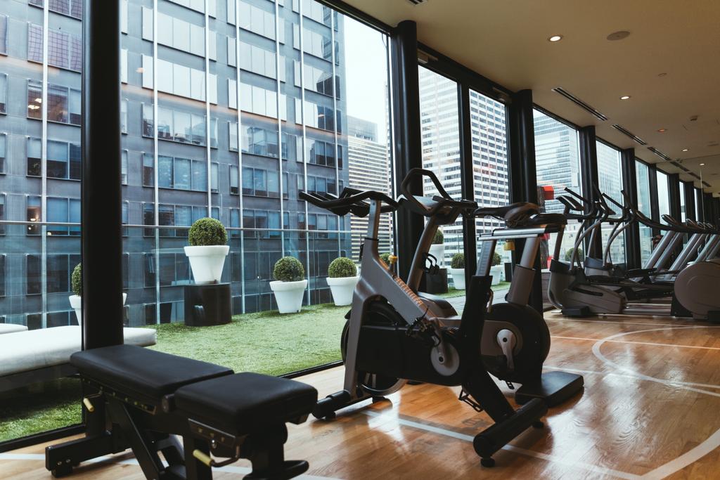close up view of exercise equipment in gym and flowerpots on balcony - Photo, Image