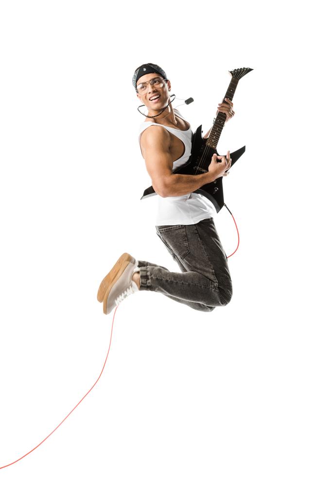 明朗快活な青年ジャンプして白で隔離のエレク トリック ギターで遊んで - 写真・画像
