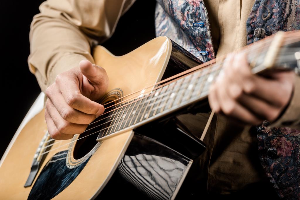 cropped image of male musician playing on acoustic guitar isolated on black - Photo, Image