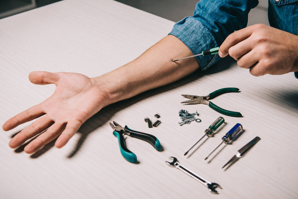 cropped view of man repairing hand with metallic tools - Photo, Image
