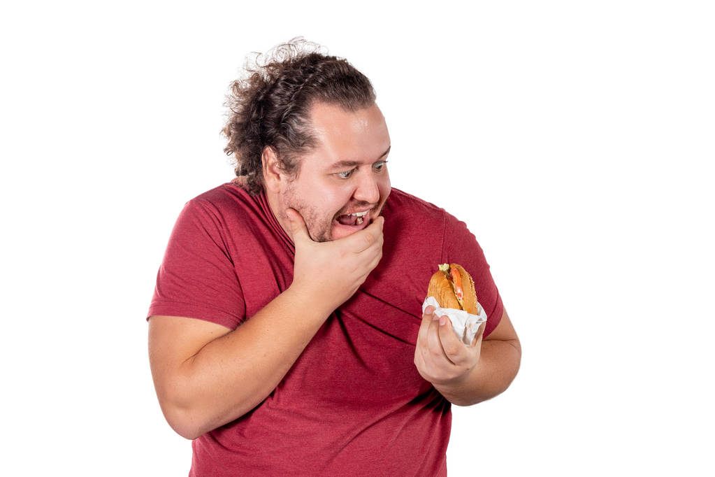 Legrační tlustý člověk jíst hamburger. Rychlé občerstvení, škodlivé jíst. Nadváha a zdravotní problémy - Fotografie, Obrázek