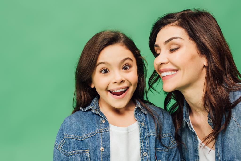 portrait of smiling mother and surprised daughter isolated on green - Photo, Image