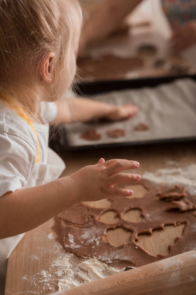 Малыш делает рождественские печенья. Рождественская концепция. Пекарные изделия. Обучение детей
 - Фото, изображение