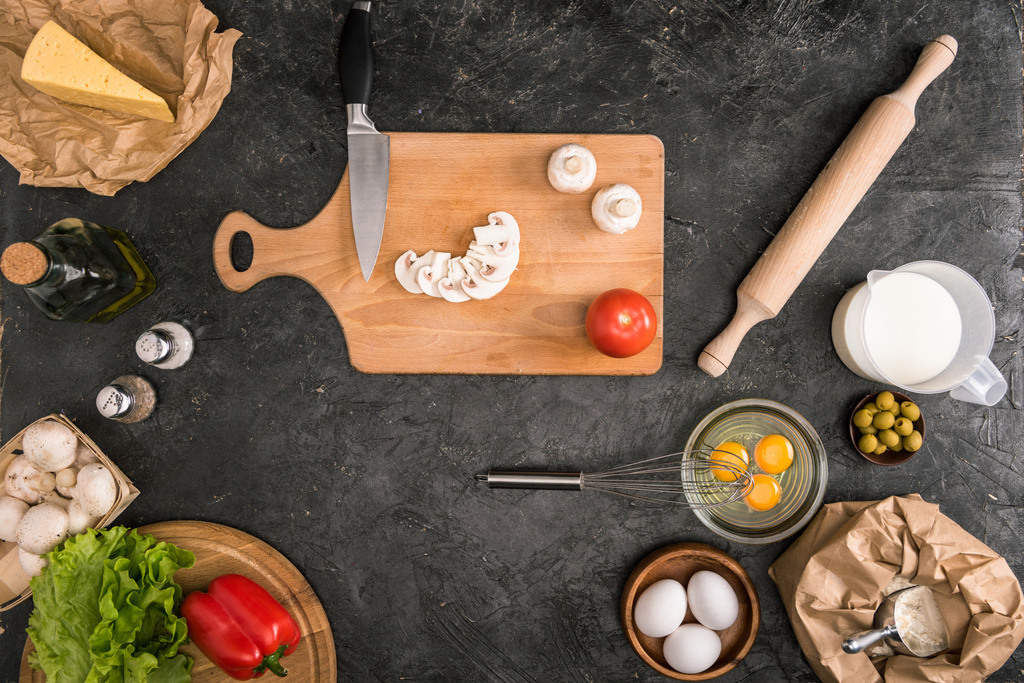 pizza ingredients and cooking utensils on grey background  - Photo, Image