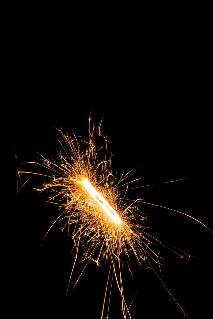 close-up view of glowing new year sparkler on black background  - Photo, Image
