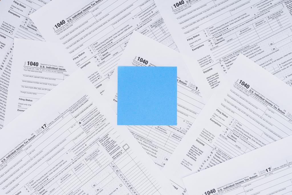 top view of empty blue card with tax forms on background  - Photo, Image
