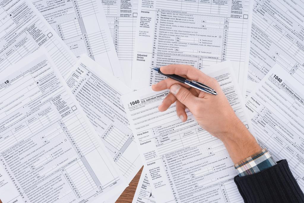 partial view of man holding pen and filling tax forms with copy space - Photo, Image