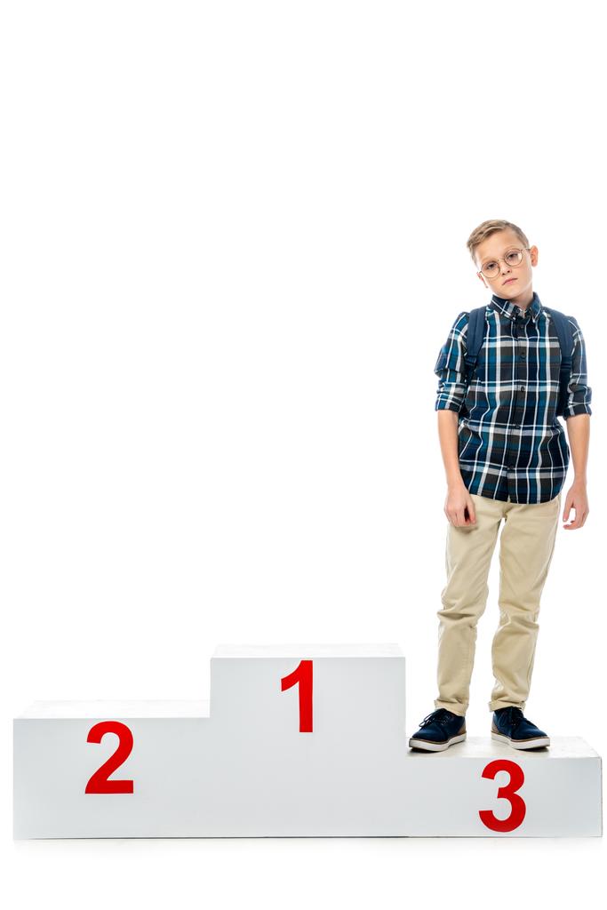 disappointed boy standing on winner podium and looking at camera isolated on white - Photo, Image