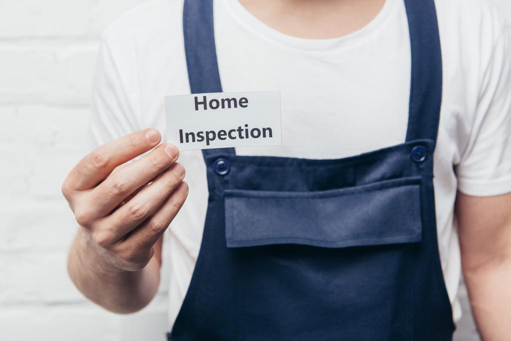 cropped image of male craftsman showing card with lettering home inspection  - Photo, Image