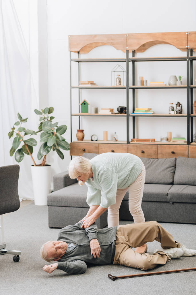 old woman helping husband who falled down on floor - Photo, Image