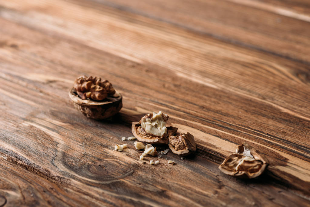 cracked walnuts as alzheimer symbol on wooden table  - Photo, Image