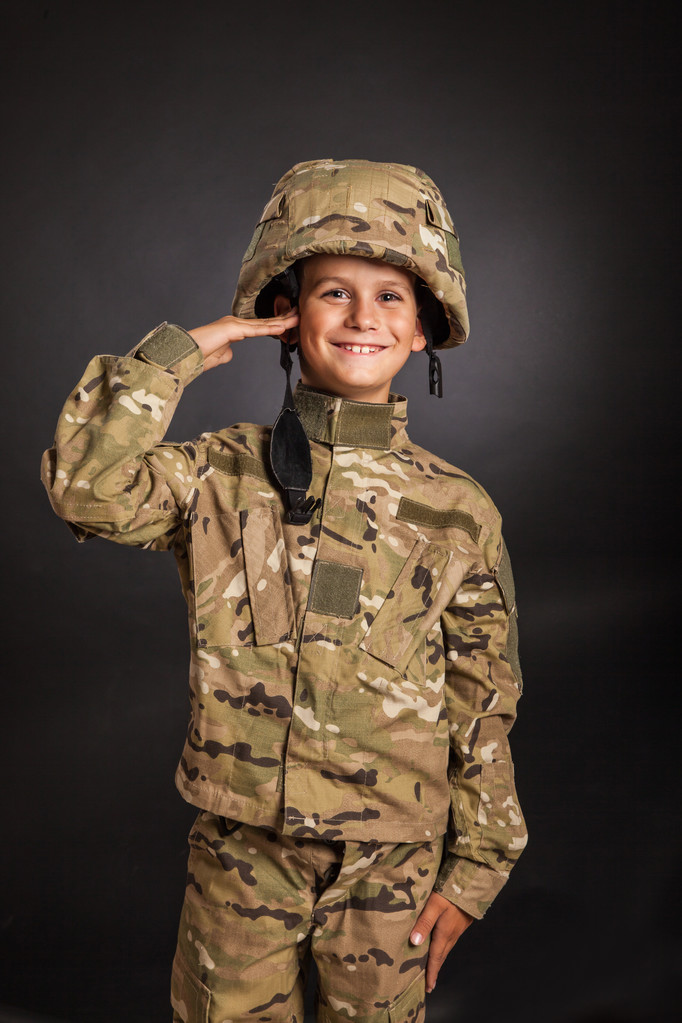 Tisztelegve katona. Fiatal fiú öltözött, mint egy katona - Fotó, kép