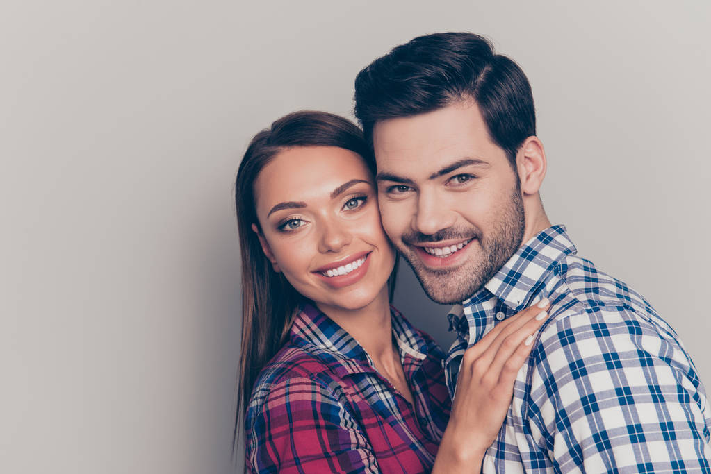 Close-up portrait of two nice lovely lovable sweet attractive cheerful people married spouses husband wife wearing checked shirt isolated over gray pastel background - Photo, Image