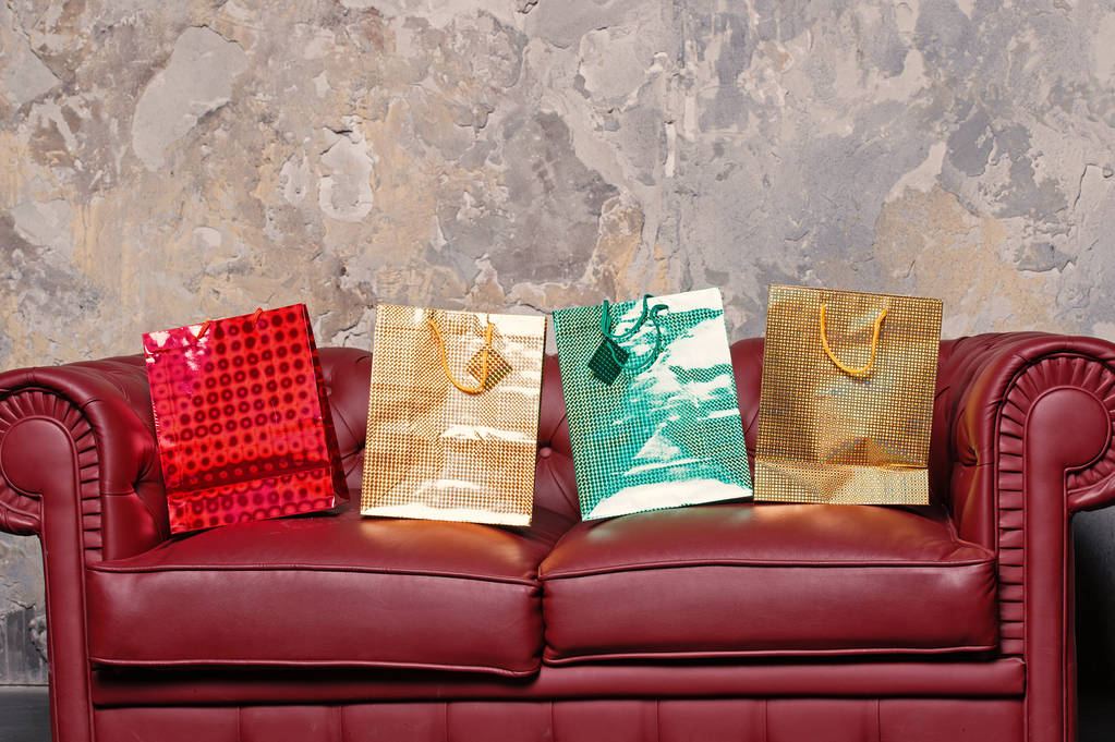 Sofa with colorful present bags - Photo, Image