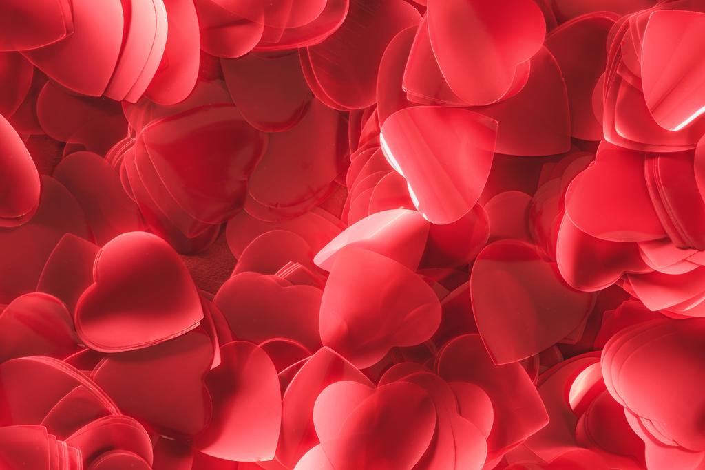 close-up view of beautiful decorative red heart shaped petals, valentines day background  - Photo, Image