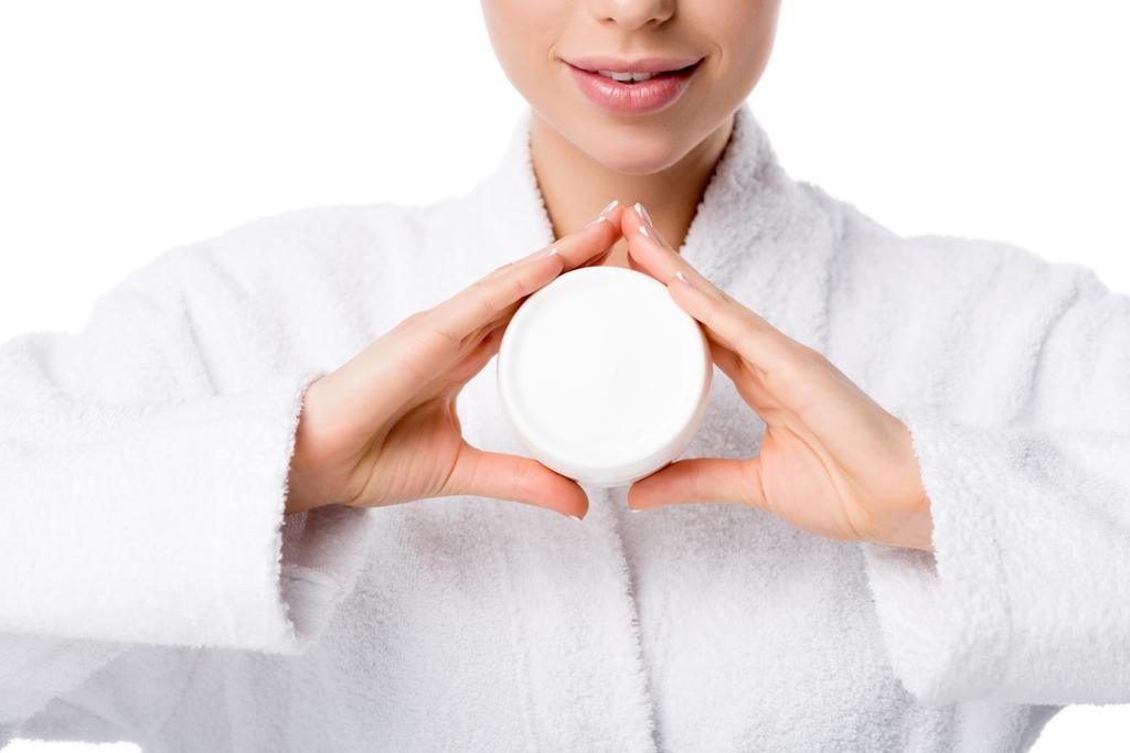 partial view of woman in bathrobe holding face cream isolated on white - Photo, Image