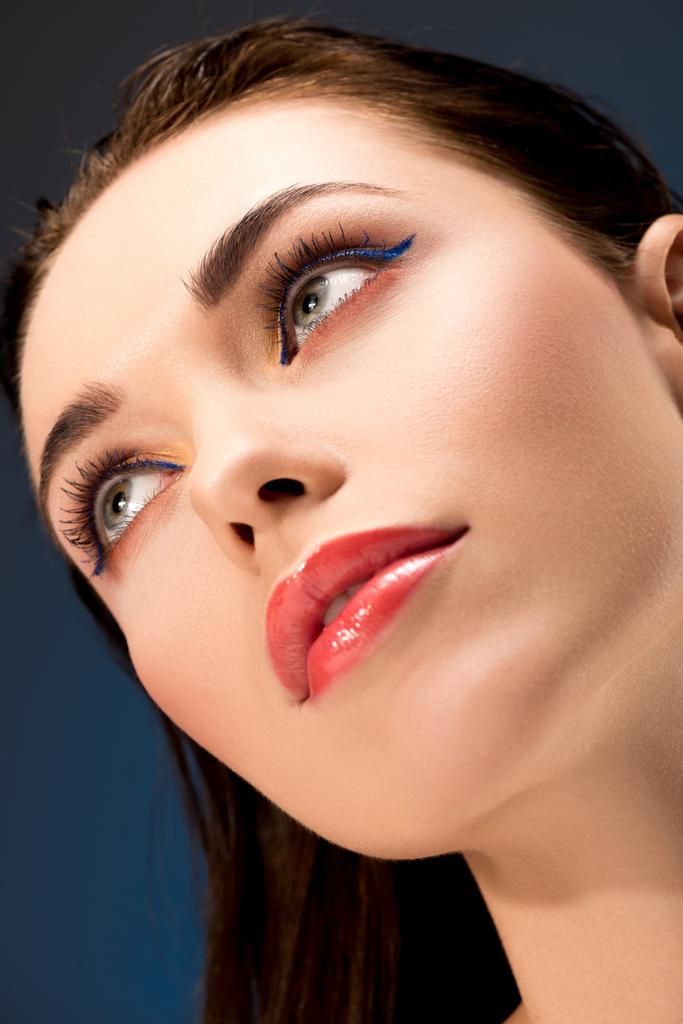 portret pięknej kobiety z czarujący makijaż patrząc od hotelu na niebieskim tle - Zdjęcie, obraz