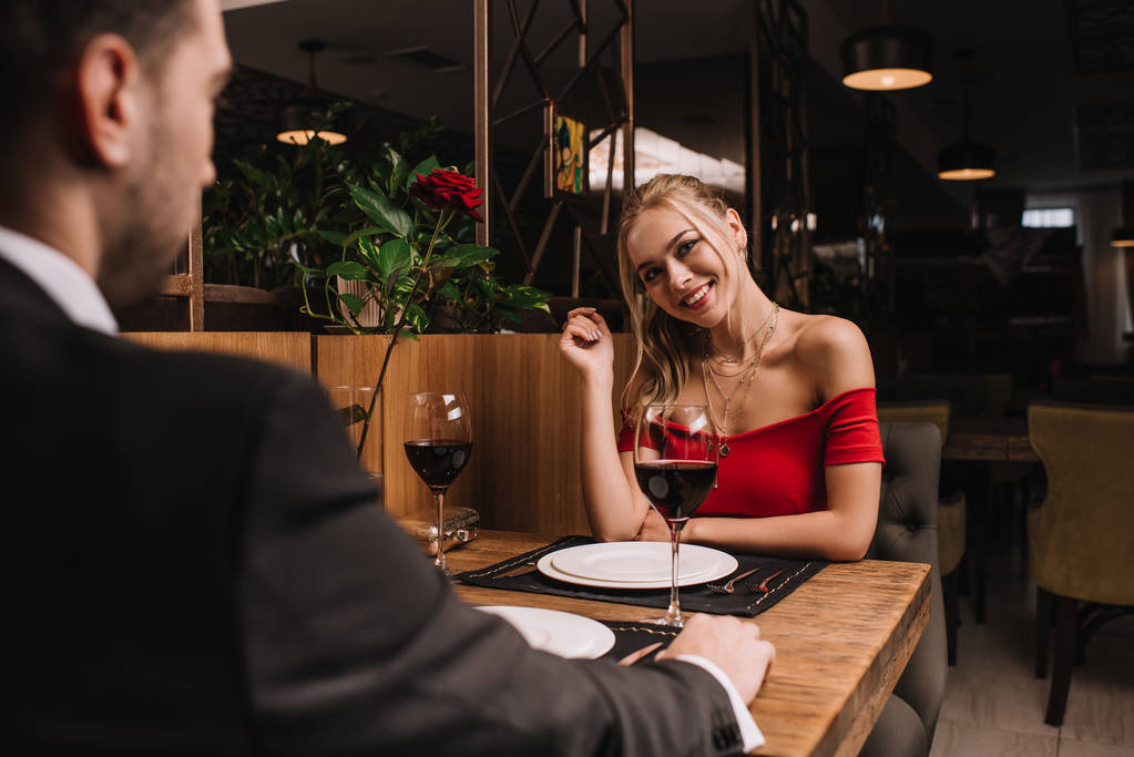 atractiva mujer coqueteando con novio en restaurante
  - Foto, Imagen