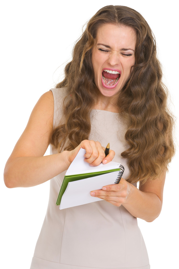 Retrato de uma jovem frustrada puxa a folha do caderno
 - Foto, Imagem