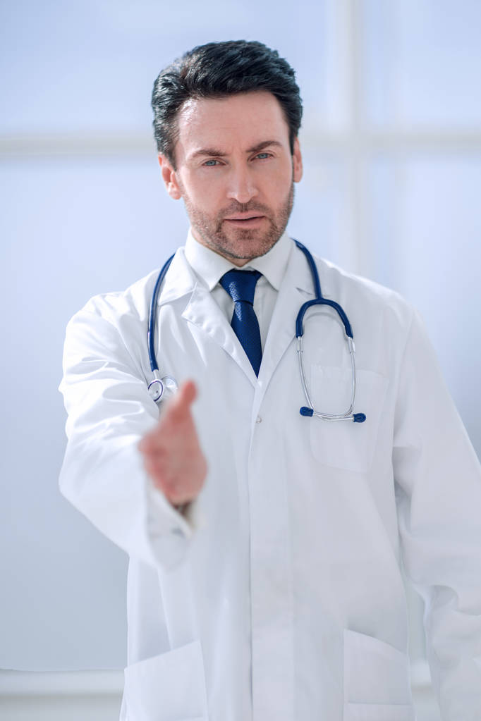 挨拶の彼の手を保持している医師の背景イメージ - 写真・画像