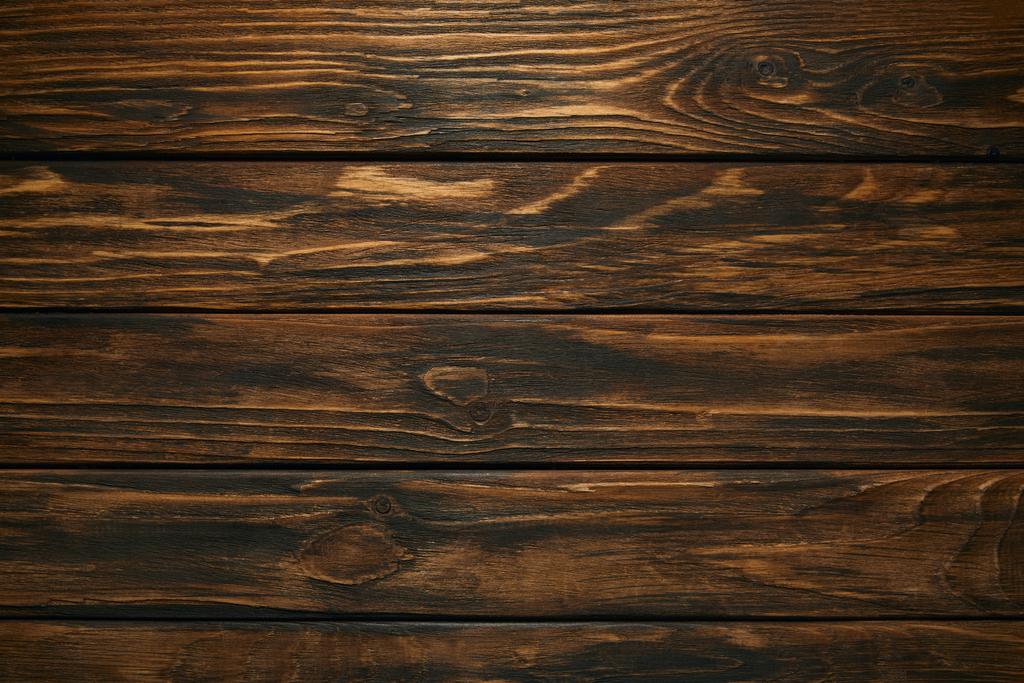 Draufsicht auf dunkelbraunen Holzhintergrund mit horizontalen Planken - Foto, Bild