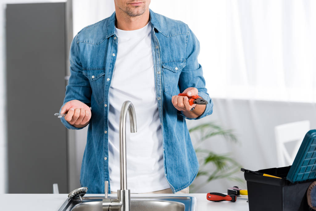 обрезанный вид человека с инструментами белый ремонт кухонной раковины
  - Фото, изображение