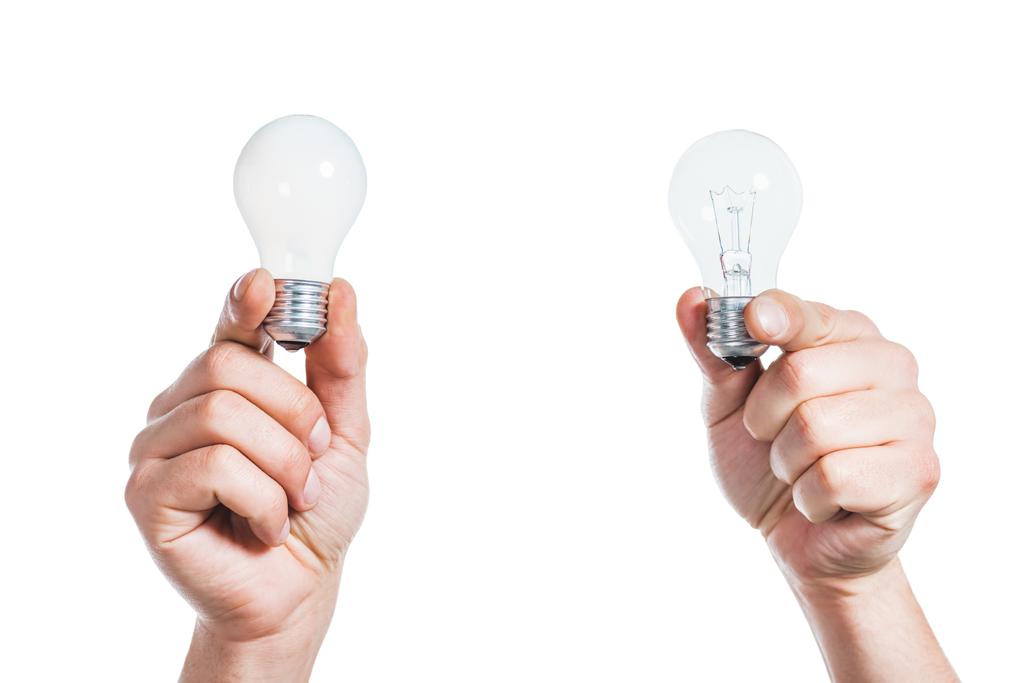 visão recortada de mãos masculinas segurando lâmpadas led em mãos isoladas em branco, conceito de eficiência energética
 - Foto, Imagem