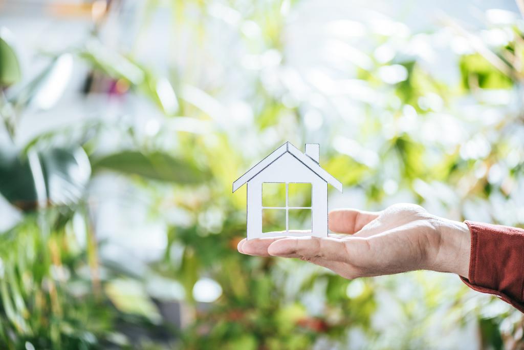 cropped view of man holding paper house in hands, energy efficiency at home concept - Photo, Image