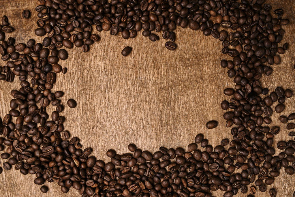 top view of roasted aromatic coffee beans on wooden table  - Photo, Image