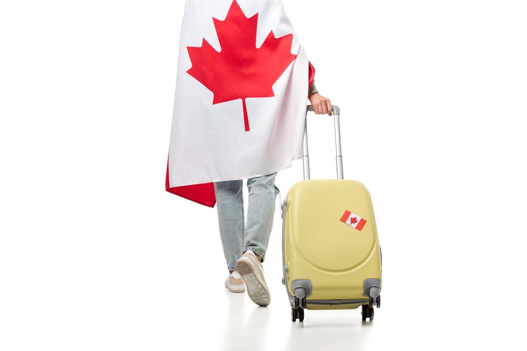 concept bijgesneden beeld van de vrouw in de Canadese vlag bedekt met koffer op wit wordt geïsoleerd, reizen - Foto, afbeelding
