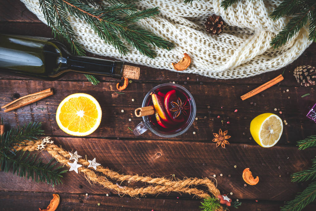 Christmas, hot mulled wine in a glass with spices and citrus fruits. A cozy, winter evening. Winter drinks. Flat lay, top view  - Photo, Image
