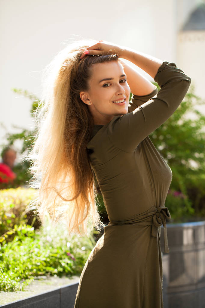 Primer plano retrato de hermosa joven rubia feliz en vestido verde, calle verano al aire libre
 - Foto, Imagen