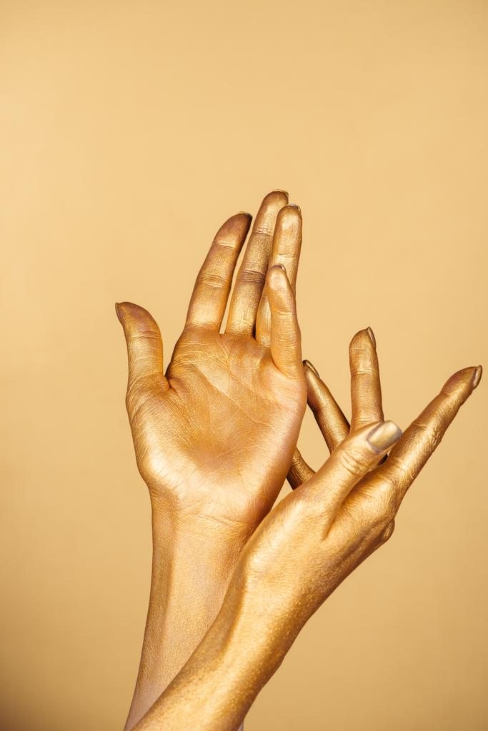 partial view of female painted hands isolated on gold - Photo, Image