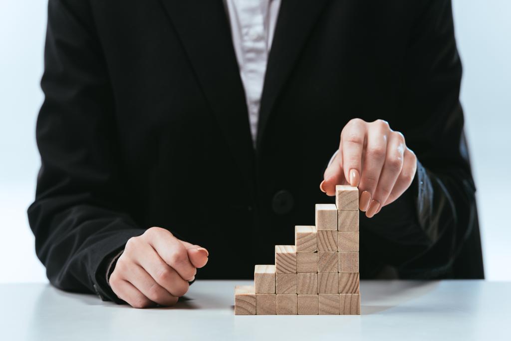 cropped view of woman with wooden blocks symbolizing career ladder - Photo, Image