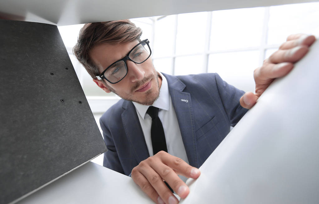 young businessman selects a folder for documents - Photo, Image