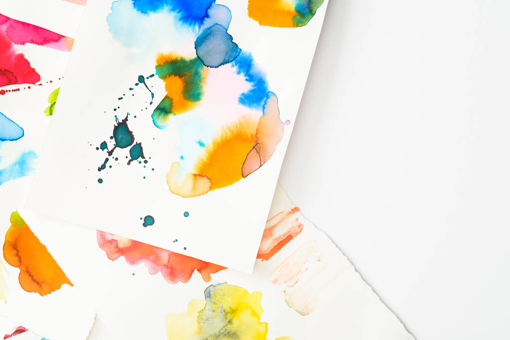 top view of papers with abstract watercolor spills on papers with copy space - Photo, Image