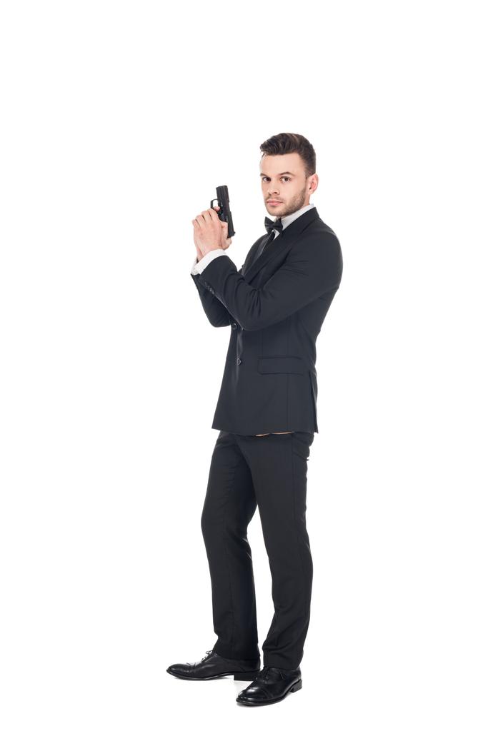elegante agente secreto en traje negro con pistola, aislado en blanco
 - Foto, Imagen