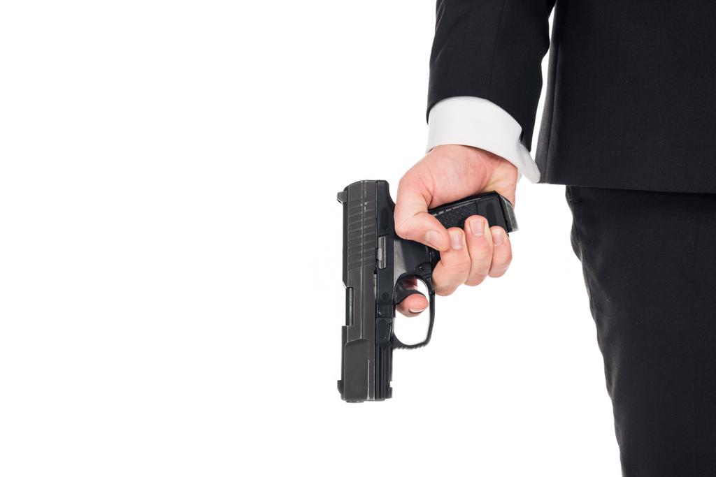 partial view of secret agent holding gun, isolated on white - Photo, Image