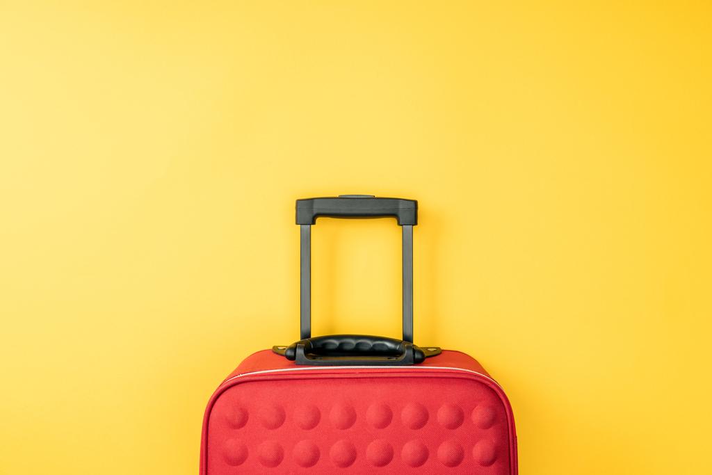 top view of red travel bag on yellow background  - Photo, Image