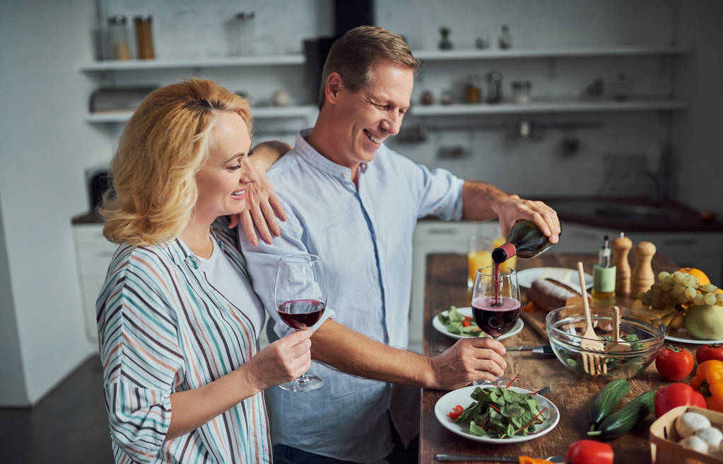 Idősebb pár a főzés, a konyha. Gyönyörű nő és jóképű férfi időt együtt otthon. Romantikus vacsora - Fotó, kép