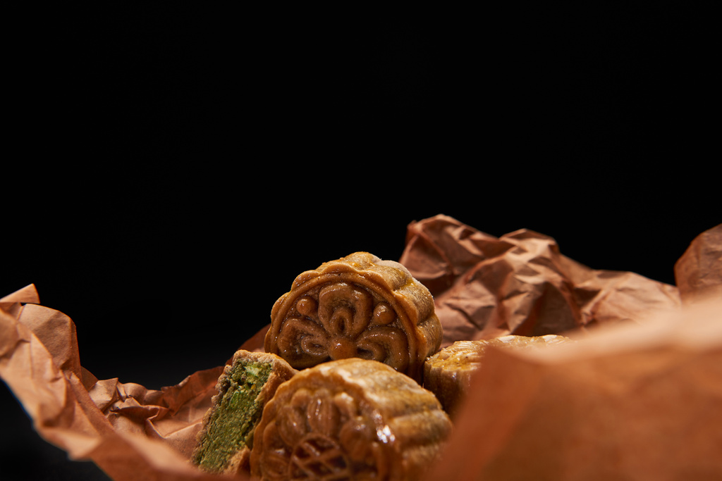 selective focus of traditional chinese mooncakes isolated on black with copy space - Photo, Image