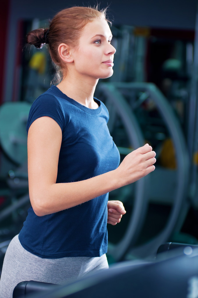 Young woman at the gym run on on a machine - Photo, Image