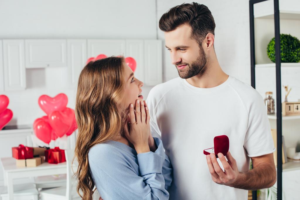 selective focus of man doing proposal at valentines day to girlfriend - Photo, Image