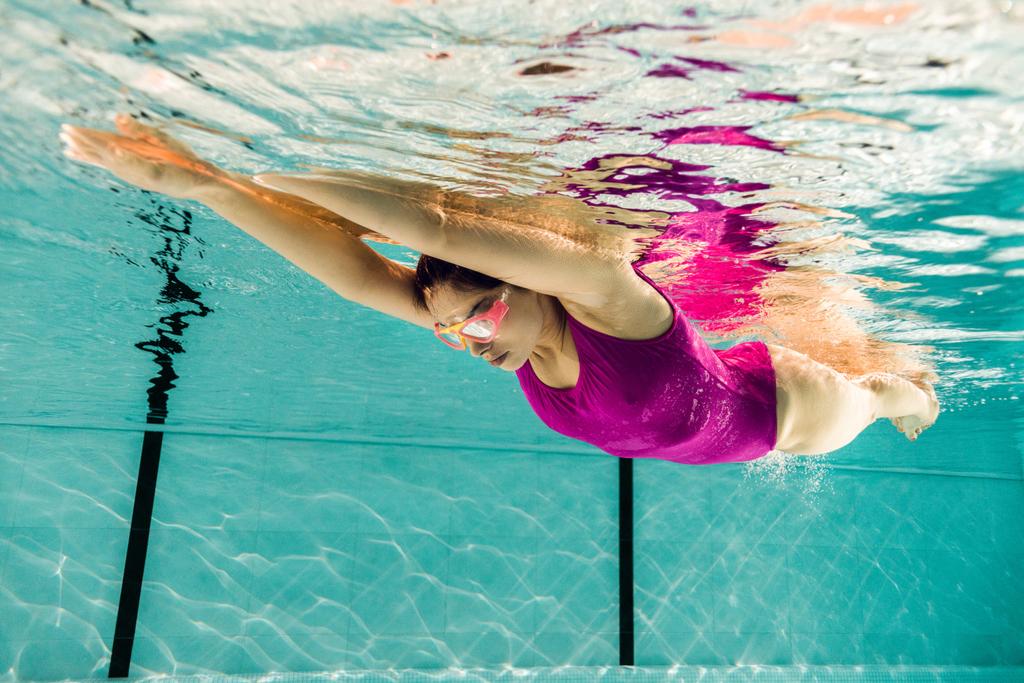 keskittynyt nainen sukellus googles uima-altaassa
 - Valokuva, kuva