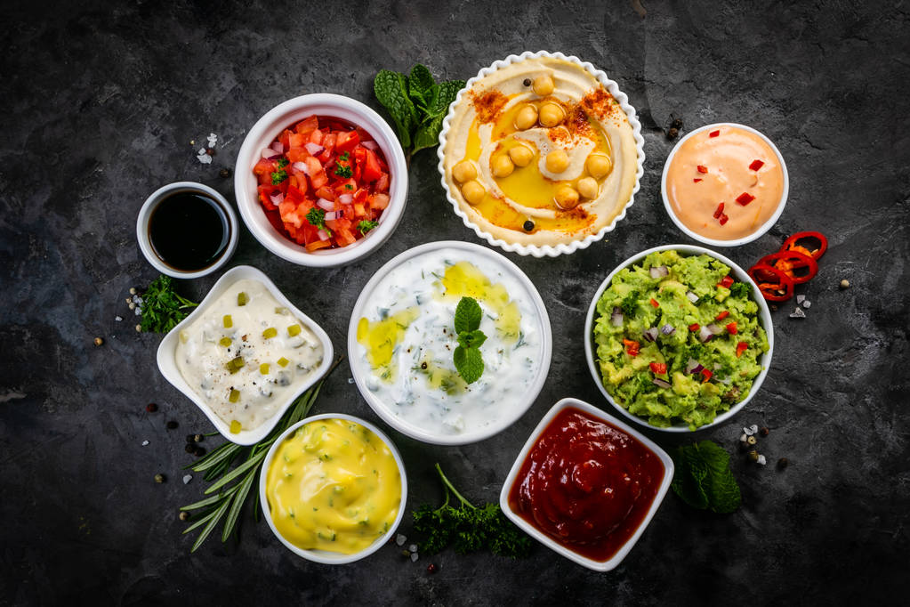 Selection of sauces in white bowls on white bowls - Photo, Image