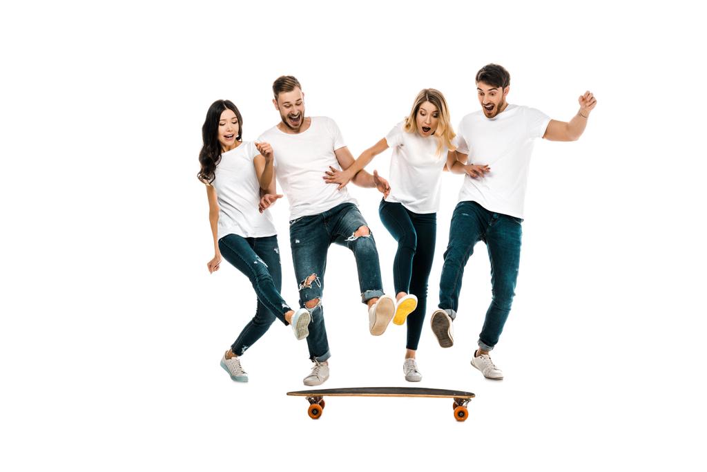 happy young friends having fun with skateboard isolated on white - Photo, Image