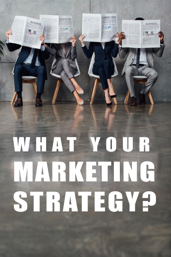 businesspeople sitting on chairs and holding newspapers in front of faces in waiting hall with what your marketing strategy question on floor   - Photo, Image